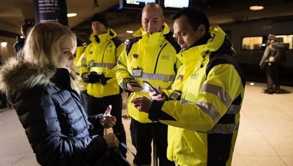 Security staff check a traveler