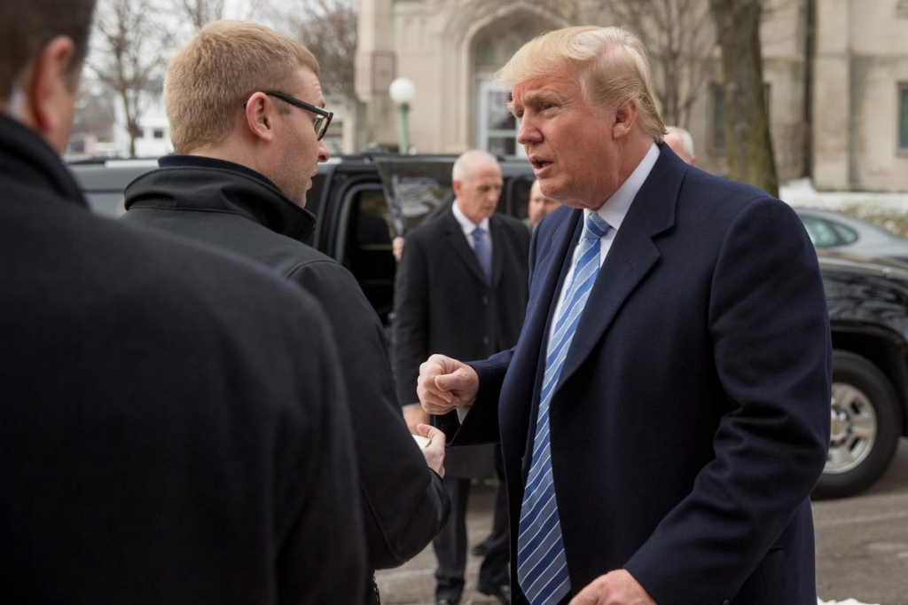 Republican presidential candidate Donald Trump signs an autograph as he arrives for service at First Presbyterian Church in Muscatine Iowa Sunday Jan. 24 2016