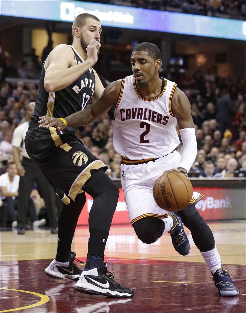 Cleveland's Kyrie Irving drives past Toronto's Jonas Valanciunas on the way to a season-high in points Monday night in Cleveland