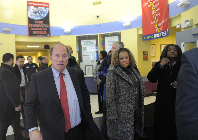 Detroit Mayor Mike Duggan left leaves Fisher Magnet Lower Academy in Detroit Tuesday Jan. 12 2016 after talking with school administrators and Detroit