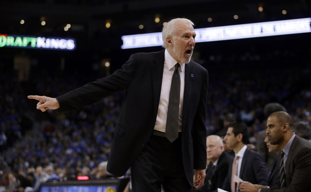 San Antonio Spurs head coach Gregg Popovich yells at players on the bench during the second half of an NBA basketball game against the Golden State Warriors