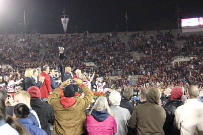 Stanford Coach David Shaw lifts Rose Bowl Trophy as Stanford players cheer