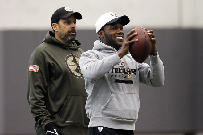 Pittsburgh Steelers wide receiver Antonio Brown right who is following NFL concussion protocol catches a pass tossed by a teammate in front of offensive coordinator Todd Haley during an NFL football practice in Pittsburgh Wednesday Jan. 13 2016. Th