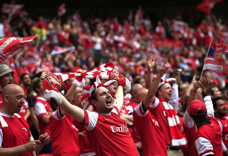 Arsenal fans cheer during the English FA Cup final match between Arsenal and Hull City at Wembly Stadium in London