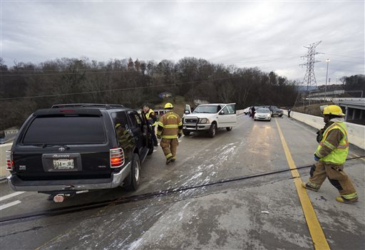 Emergency personnel work the scene were a motorist lost control and jumped the guardrail after hitting a patch of ice on US 27 North in Chattanooga Tenn. on Wednesday, Jan. 20 2016. A winter storm with freezing rain left slick roads for morning commut