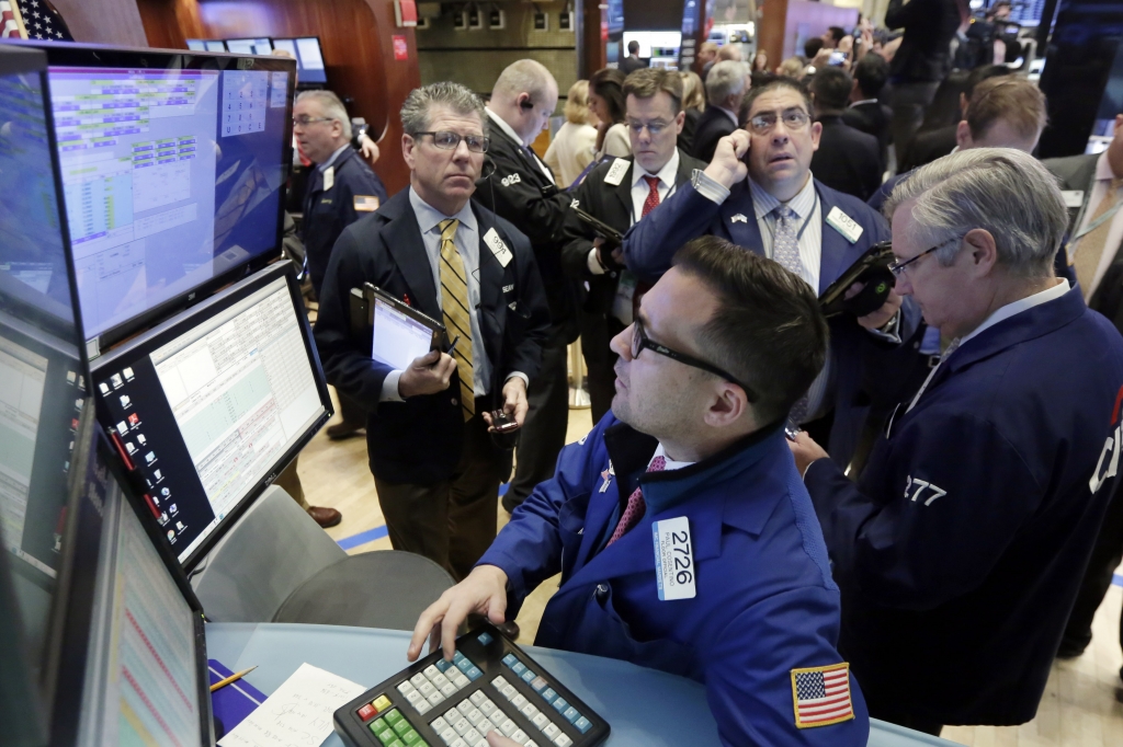 Financial Markets Wall Street Specialist Paul Cosentino foreground works with traders at his post on the floor of the New York Stock Exchange Wednesday Jan. 27 2016. Stocks are opening broadly lower as energy companies take another tumble and after A