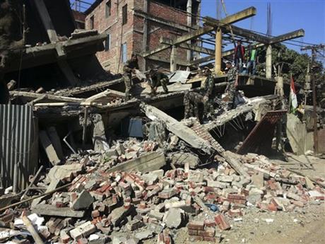 Indian soldiers remove debris from a house that collapsed in an earthquake in Imphal capital of the northeastern Indian state of Manipur Monday Jan. 4 2016. A 6.7 magnitude earthquake hit India's remote northeast region before dawn on Monday. (AP