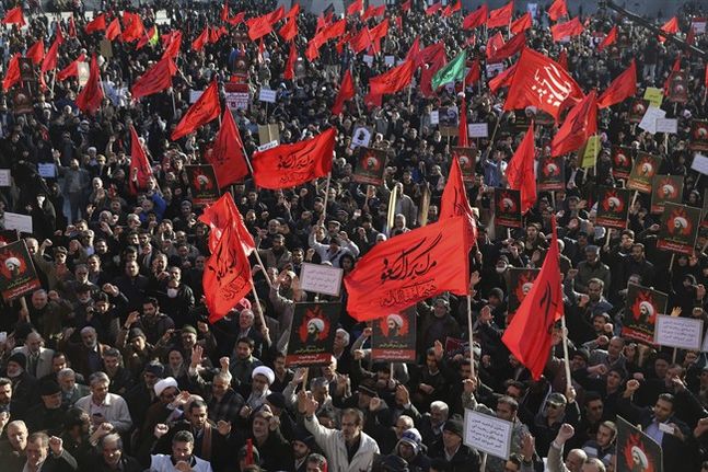 Iranian demonstrators chant slogans and hold anti Saudi placards and flags during a rally to protest the execution by Saudi Arabia last week of Sheikh Nimr al-Nimr a prominent opposition Saudi Shiite cleric by Saudi Arabia in Tehran Iran Monday Jan