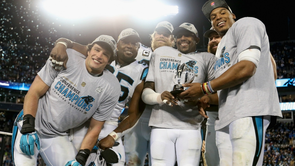 Cam Newton #1 of the Carolina Panthers celebrates with his teammates and the George Halas Trophy after defeating the Arizona Cardinals with a score of 49 to 15 to win the NFC Championship Game at Bank of America Stadium on Jan. 24 2016 in Charlotte N.C