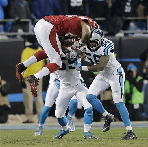 Arizona Cardinals Darren Fells is hit by Carolina Panthers Thomas Davis and Luke Kuechly after catching a pass during the first half the NFL football NFC Championship game Sunday Jan. 24 2016 in Charlotte N.C