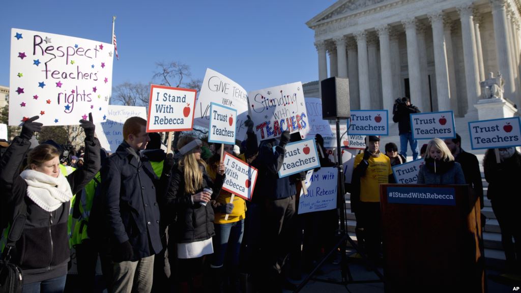 People participate in a rally at the Supreme Court in Washington Jan. 11 2016 as the court heard arguments in the 'Friedrichs v. California Teachers Association&#39 case