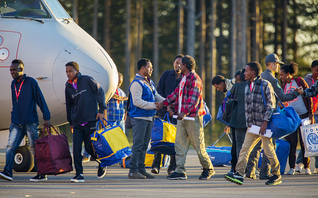 Eritrean asylum seekers arrive by an Italian Financial police aircraft to Lulea Airport Kallax northern Sweden Friday Oct. 9 2015. Italy bid farewell Friday to 19 Eritreans ó the first of an estimated 160,000 refugees to be resettled throughout Europ