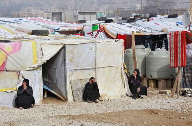 Syrian refugees women sitting outside their tents during the visit of Filippo Grandi the United Nations High Commissioner for Refugees UNHCR to a camp in the town of Saadnayel in the Bekaa valley Lebanon Friday Jan. 22 2016