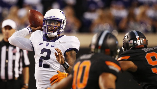 TCU quarterback Trevone Boykin throws a touchdown pass under pressure from Oklahoma State defenders in the fourth quarter of an NCAA college football game in Stillwater Okla. Saturday Nov. 7 2015. Oklahoma State won 49-29