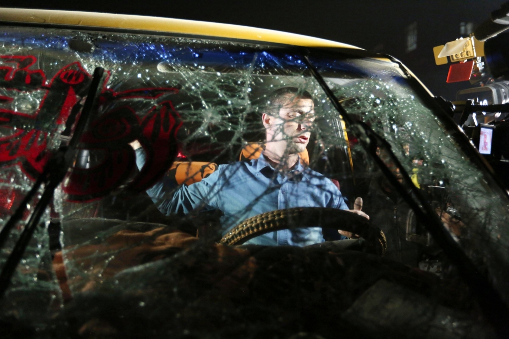 Afghanistan0121 An uninjured Afghan driver is seen through the shattered windshield of a car at the site of a suicide attack Wednesday near the Russian embassy in Kabul Afghanistan