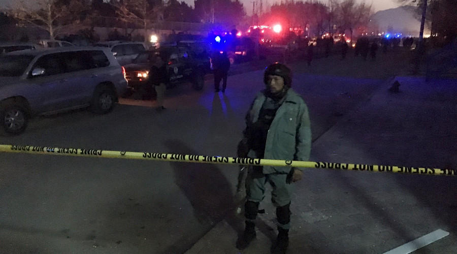 An Afghan policeman keeps watch near the site of a blast in an area close to the Russian embassy in the west of the Afghan capital of Kabul