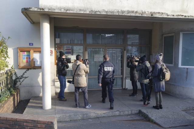 A police enters a pre-school Dec. 14 2015 in Paris suburb Aubervilliers. French anti-terrorism authorities are investigating an attack on Dec. 14 on a preschool teacher in a Paris suburb by a masked assailant with a box-cutter and scissors who invoked