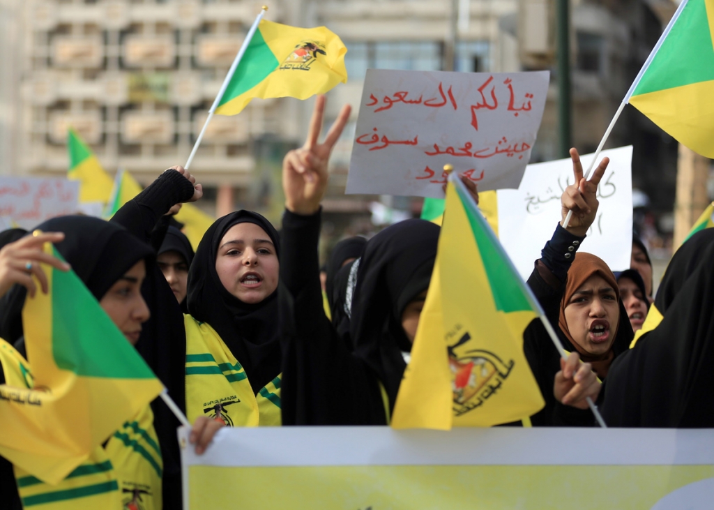 Shiite women wave Shiite militias flags during a rally to protest the execution of Saudi Shiite Sheik Nimr al Nimr by Saudi Arabia last week in Tahrir Square Baghdad Iraq on Wednesday. While many Iraqi Shiites took to the streets in outrage over Saudi