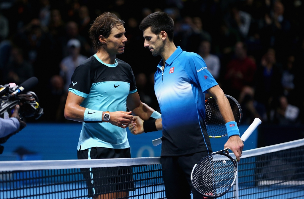 Novak Djokovic of Serbia shakes hands at the net after his straight sets victory against Rafael Nadal of Spain during the men's singles semi final match on day seven of the Barclays ATP World Tour Finals at O2 Arena