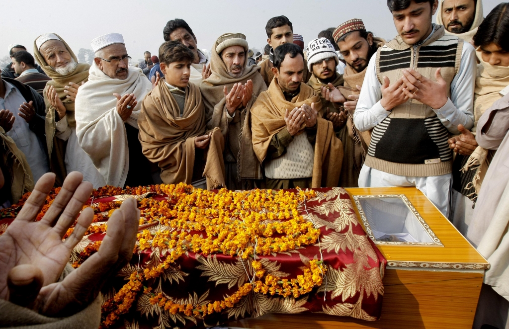 Pakistani villagers offer prayers Thursday during the funeral of a victim killed in an attack on Bacha Khan University in Charsadda Pakistan