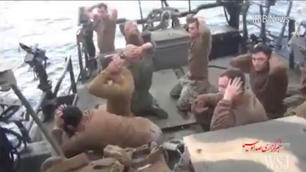 A screenshot of a video released by Iran showing several Americans kneeling with their hands clasped behind their heads