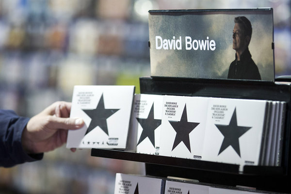 A customer picks up a copy of'Blackstar the latest album by British musician David Bowie in a branch of HMV in central London