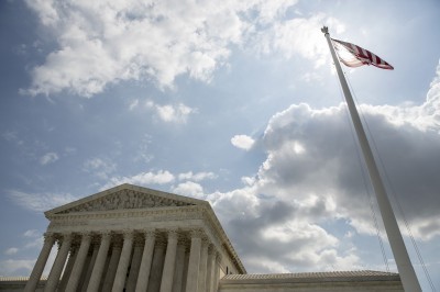 The U.S. flag flies in front of the Supreme Court in Washington in May 2015