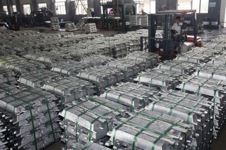 A worker drives a forklift to transport aluminum bars at a factory in Anshun Guizhou province China