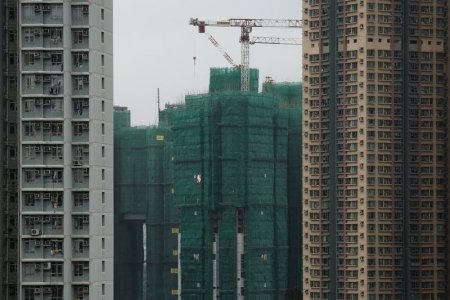 Construction cranes are seen at the building site of a new private housing complex in Hong Kong China