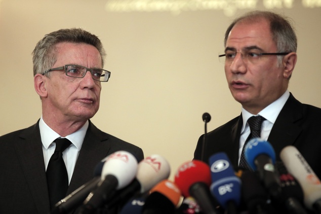 German Interior Minister Thomas de Maiziere left listens to his Turkish counterpart Efkan Ala right during a joint news conference in Istanbul Wednesday