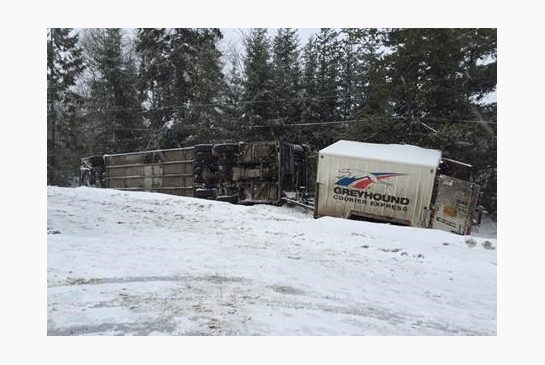 A Greyhound bus with nine people on board has flipped on its side in icy road conditions on Highway 97 near Prince George in central B.C. Thursday Jan.14 2016. B.C. Emergency Health Services spokeswoman Preet Grewal says five ambulances rushed to the