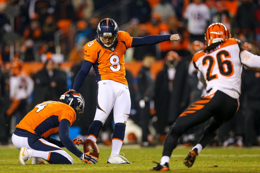 Kicker Brandon Mc Manus #8 of the Denver Broncos kicks the game-winning 37-yard field goal in overtime as punter Britton Colquitt #4 holds at Sports Authority Field at Mile High