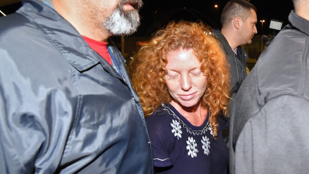 Tonya Couch centre is taken by authorities to a waiting car after arriving at Los Angeles International Airport on Thursday