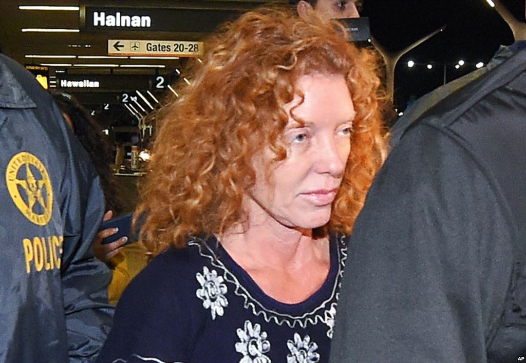 Tonya Couch is taken by authorities to a waiting car after arriving at Los Angeles International Airport Dec. 31 2015