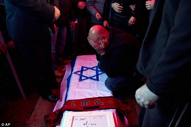 Tragedy David Bekel the father of Alon mourns over the coffin of his son during his funeral in Karmiel northern Israel