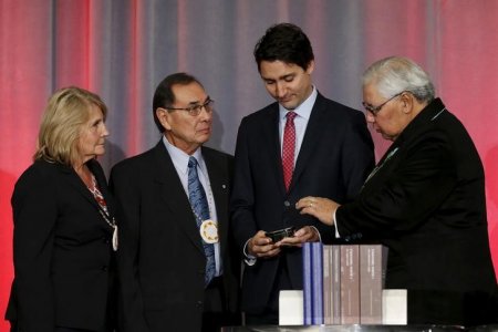 Canada's Prime Minister Justin Trudeau is presented with an copy the Truth and Reconciliation Commission's final report by Commissioner Marie Wilson, Commissioner Chief Wilton Littlechild and Justice Murray Sinclair in Ottawa Canada