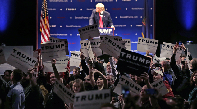 Supporters turn to show their support as a protestor interrupts an address by Republican presidential candidate Donald Trump during a campaign stop at the Fl