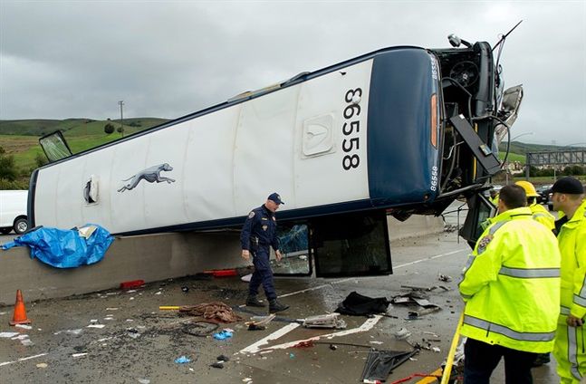 A California Highway Patrol investigator examines the scene of a fatal Greyhound bus crash Tuesday Jan. 19 2016 in San Jose Calif. The bus flipped on its side while traveling north on Highway 101 according to the San Jose Fire Department. (AP