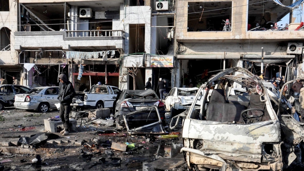 Two bombs have killed 22 and injured more than 100 in the Syrian government-controlled city of Homs