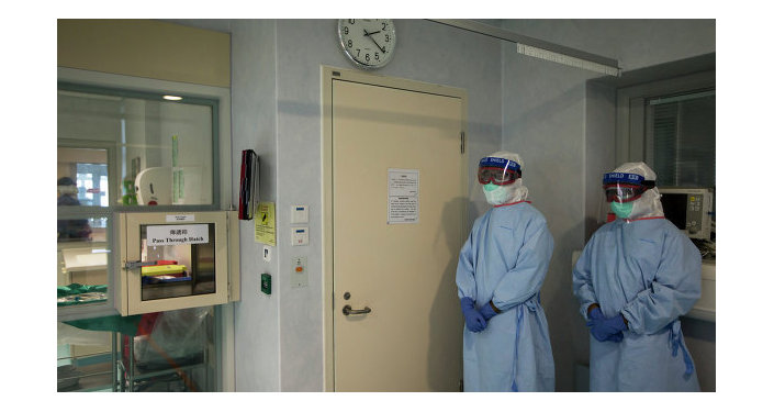 Doctors in protective suits in an isolation ward equipped for Ebola cases