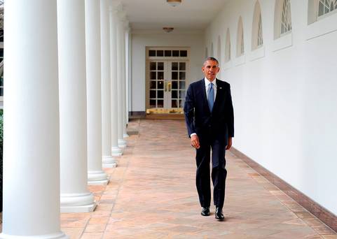 U.S. President Barack Obama walks down the colonnade from the Oval Office at The White House in Washington