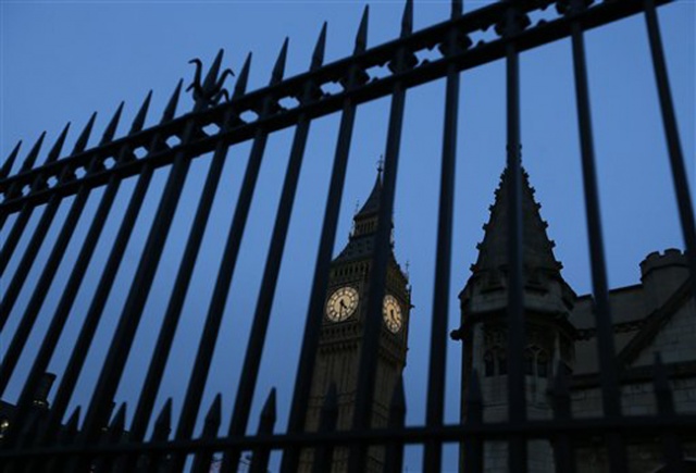 Big Ben in the Elizabeth Tower is seen through railings at Britain's Parliament buildings in Westminster in London Monday Jan. 18 2016. A proposal to ban Donald Trump from the United Kingdom because of his comment to ban Muslims from entering the Unit