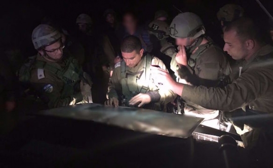 Israeli security forces searching at the scene of a fatal stabbing of a Jewish woman in her 30s in the West Bank settlement of Otniel