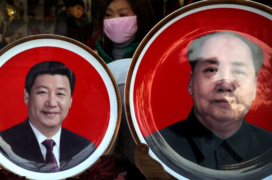 A woman looks at souvenir plates bearing images of Chinese President Xi Jinping left and late Chinese leader Mao Zedong on display for sale at a shop near Tiananmen Square in Beijing Sunday Jan. 17 2016. Tsai Ying-wen's enjoys a broad mandate from