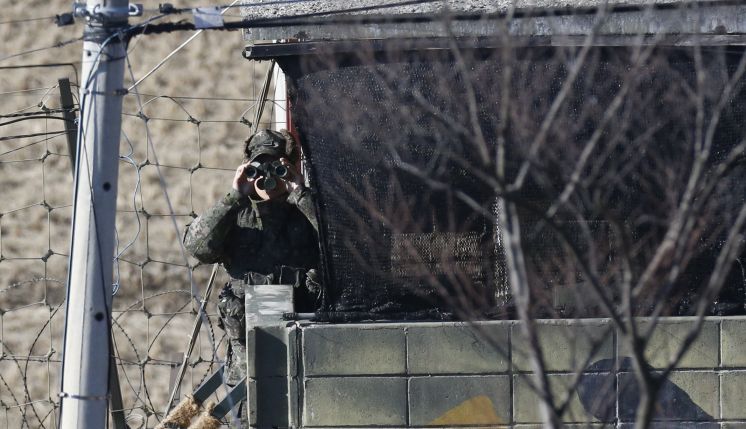 A South Korean soldier looks through a pair of binoculars Thursday near the border village of Panmunjom that has separated the two Koreas since the Korean War in Paju South Korea. In response to North Korea's latest nuclear test South Korea on Thursday