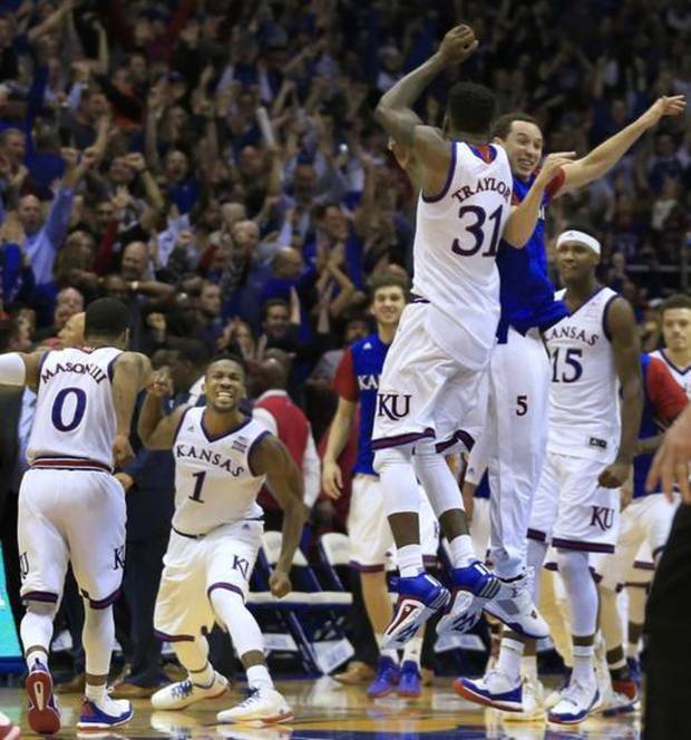 KU;s Jamari Traylor and Evan Manning leap into the air as Frank Mason III and Wayne Selden Jr. celebrate a triple-overtime victory over OU