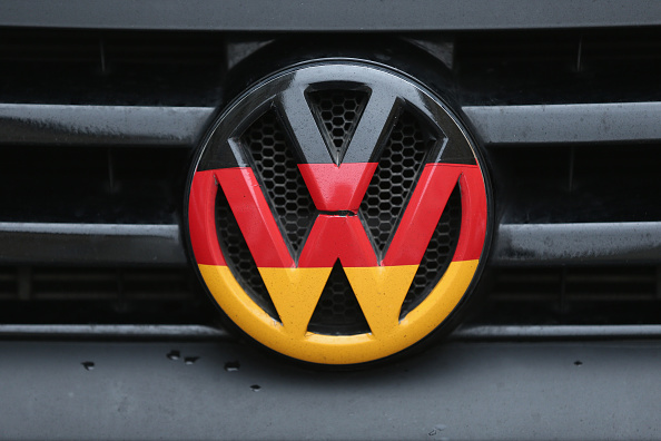 A Volkswagen logo and hood ornament in the colors of the German flag is visible on the front grille of a car