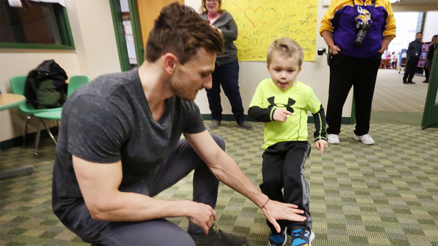 Max Birdwell 4 kicks a football from the hold of Vikings kicker Blair Walsh during a visit to Northpoint Elementary School Thursday Jan. 14 2016 in Blaine Minn