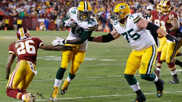 Green Bay Packers running back James Starks carries the ball to score a touchdown past Washington Redskins cornerback Bashaud Breeland during the second half in a NFC Wild Card playoff football game