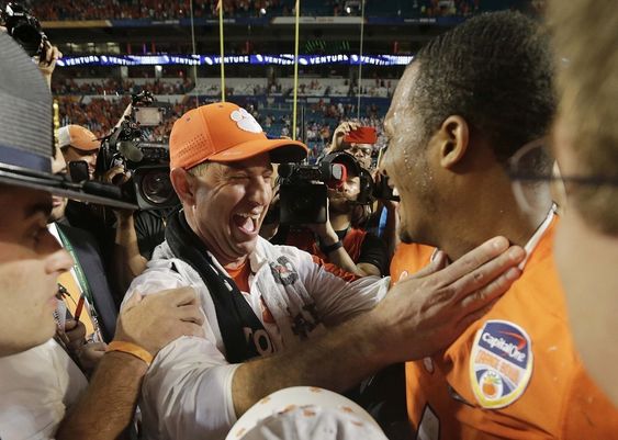 Dabo Swinney and quarterback Deshaun Watson congratulate each other on the field after their team won the Orange Bowl NCAA college football semifinal playoff game against Oklahoma Thursday Dec. 31 2015 in Miami Gardens F